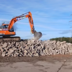14 Tonne Crusher Bucket on stone pile in action