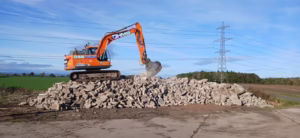 14 Tonne Crusher Bucket on stone pile in action