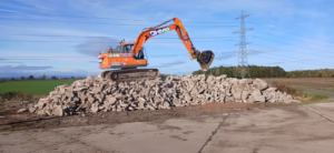 14 Tonne Crusher Bucket on stone pile crushing rubble