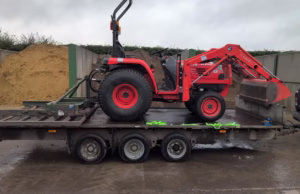 compact tractor with loader on trailer