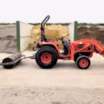 side view of compact tractor with roller attached